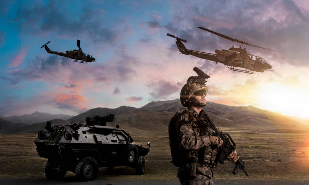 Military Operation Battlefield with a soldier, armored vehicle and flying helicopters at sunset body armor stock pictures, royalty-free photos & images