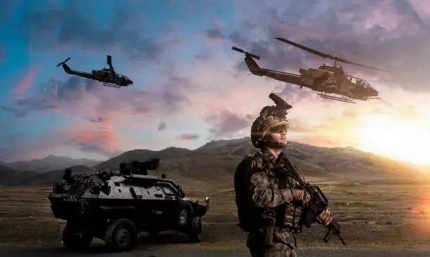 Battlefield with a soldier, armored vehicle and flying helicopters at sunset
