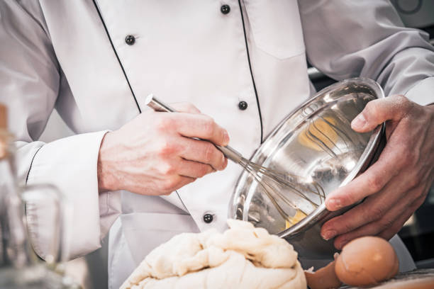istock Chef Whisking Batter And Preparing Dough In Kitchen. 1225668143