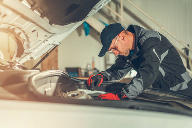istock Mechanic Fixing Components Under Car Hood. 1225669268