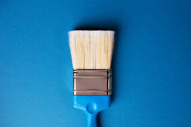 istock Paint brush on a blue background, repair concept. 1225669759