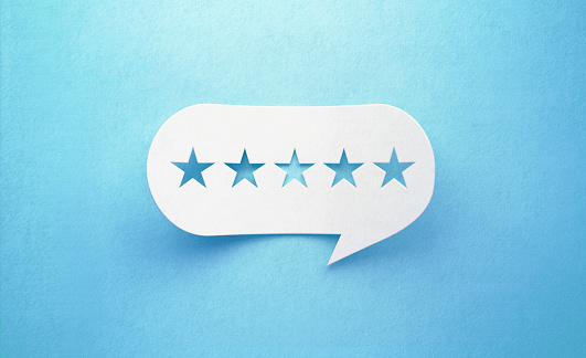 Five stars drawn white chat bubble on blue background. Horizontal composition with copy space. Rating and survey concept.