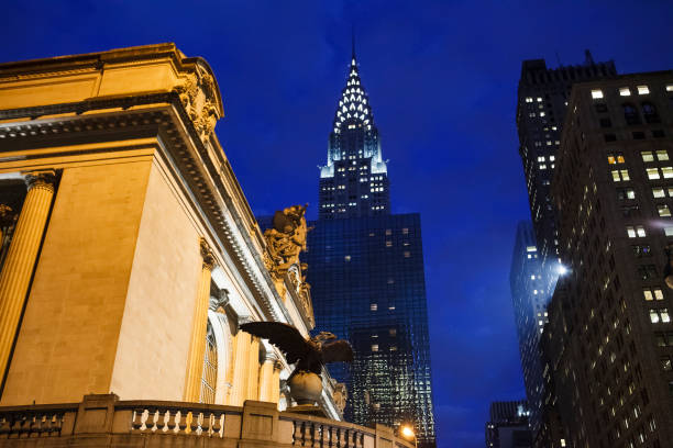 Grand Central Eagle and Chrysler Building New York City Evening New York, New York, USA -  March 1, 2016: One of the Eagles from the previous Grand Central can be seen in the foreground with the Chrysler Building in the background in the evening. chrysler building eagles stock pictures, royalty-free photos & images