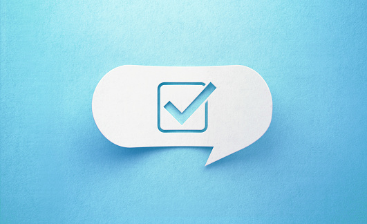 Check mark icon white chat bubble on  blue background. Horizontal composition with copy space. Survey concept.