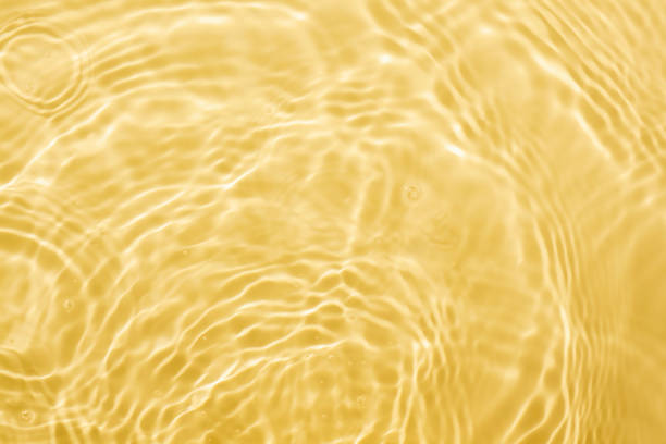 istock Yellow gold liquid cosmetic water gel with circular rippling wave effect 1225672671
