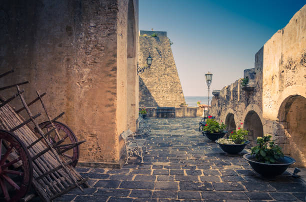 Courtyard old medieval castle Castello Ruffo, Scilla, Italy Scilla, Italy, May 10, 2018: Courtyard old medieval knight's castle on rock Castello Ruffo with stone ancient walls, street lamps, vases castle scilla stock pictures, royalty-free photos & images