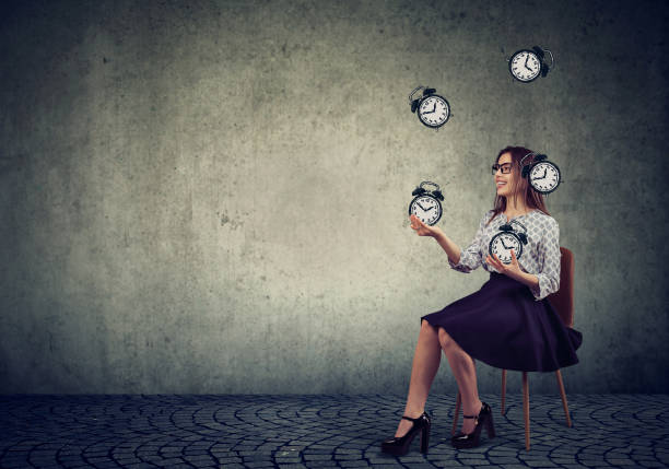 istock Woman juggling with alarm clocks 1225681796