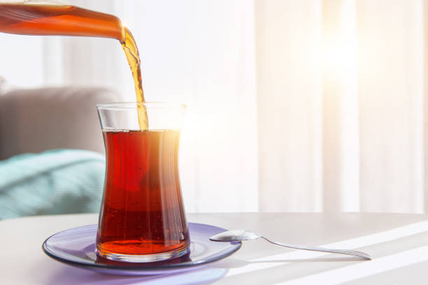 istock Blacktea, tea is pouring from teapot and tea glass served on coffee table 1225684590