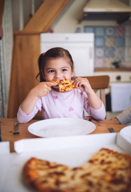 istock Cute Girl Eating Pizza 1225684804