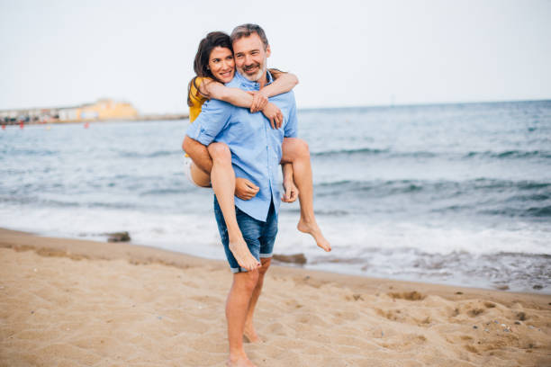 istock Happy couple having fun on the beach 1225684858