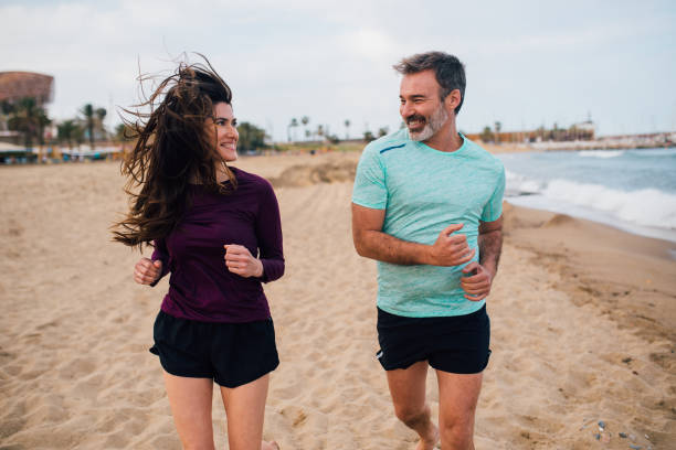 istock Happy couple jogging on the beach 1225684891