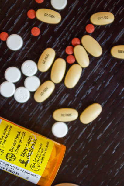 istock An array of pills scattered on a wooden surface 1225685660