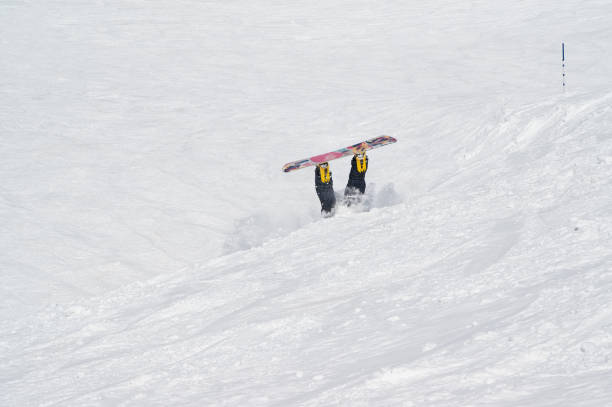 istock Snowboarder fall down on snowy off-piste ski slope 1225686332