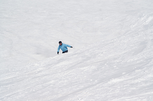 Active lifestyle, Vital female snow skier skiing, enjoying on sunny ski resorts. Skiing carving at high speed.  Alps  ski area. Ski resort Livigno. italy, Europe.