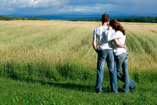 Young Couple Overlooking Farmland Hugging, Ile D'orleans, Quebec