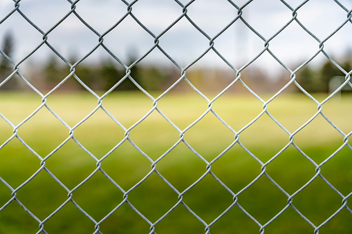 Close up photo of an elevated Platform Tennis, Paddle Ball courts chicken wire fence.