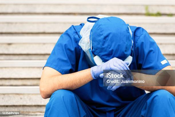 Serious Overworked Very Sad Male Health Care Worker Stock Photo - Download Image Now
