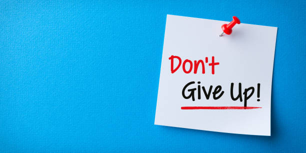 istock White Sticky Note With Don't Give Up And Red Push Pin On Blue Background 1225696369