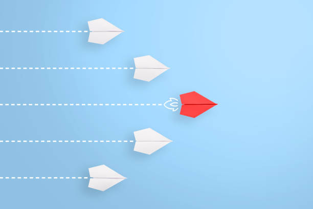 istock Leadership concepts with red paper airplane leading among white 1225696377