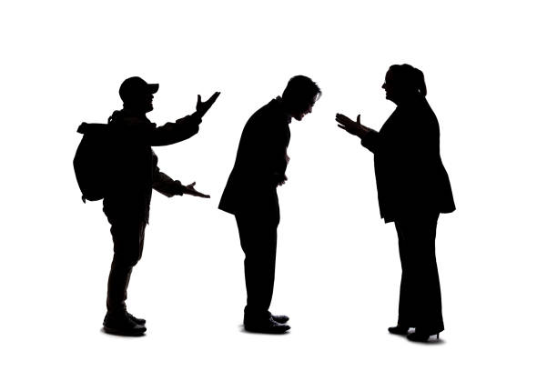Full length profile shot of a mature woman talking to an elderly man isolated on white background