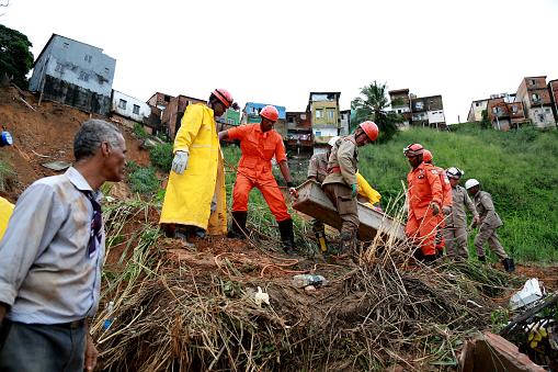 salvador, bahia / brazil - april 28, 2015: members of the fire department of Bahia are seen working to rescue the body of a victim in a collapsed area of a property in the community of Barro Branco in the city of Salvador.\