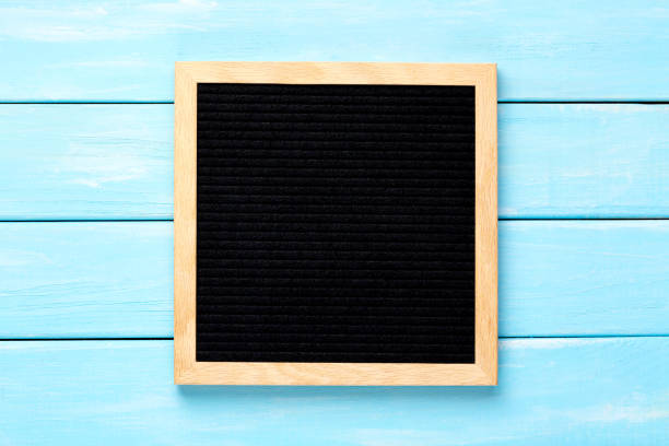 istock Empty black letterboard on blue wooden table. Design mockup 1225704460