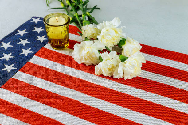 istock Striped american flag with flowers and candle. 1225704583