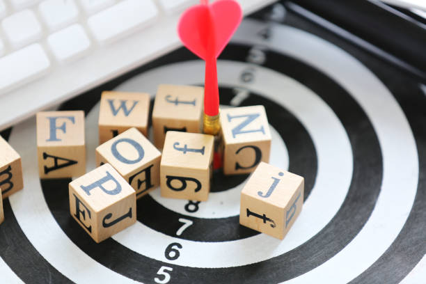 istock wooden cube with alphabet on target board and white keyboard 1225706578