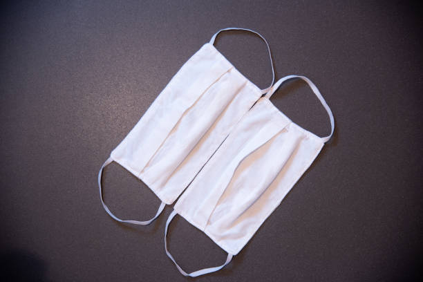 istock White protective mask used to prevent coronavirus on a neutral background. Covid-19. 1225713805