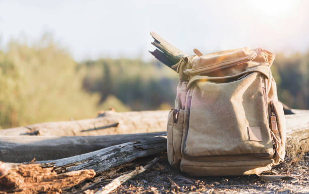 istock Travel and active lifestyle concept. Old canvas backpack on forest background 1225714389