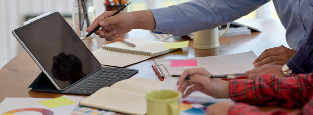 istock Side view of businesspeople consulting on their project on worktable 1225716527