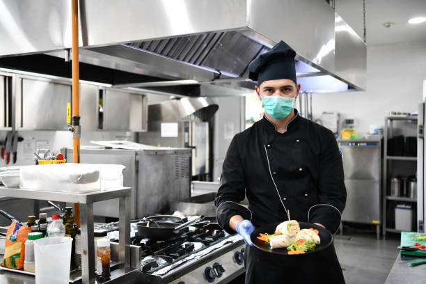istock chef cook wearing face protective medical mask for protection from coronavirus 1225719326