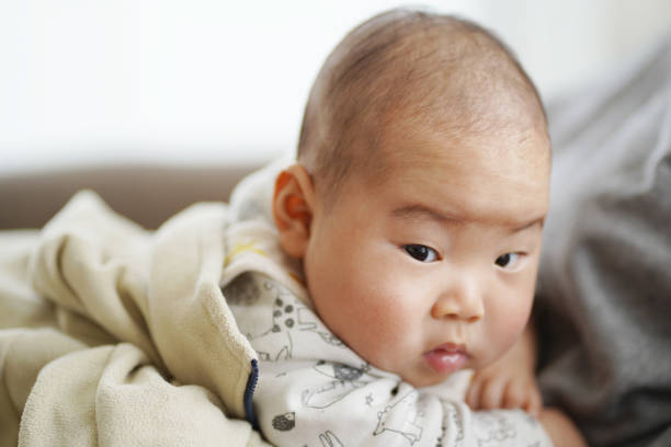 istock A Japanese baby being held by his mother. 1225719720