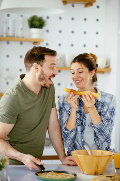 istock Young couple making pancakes at home. 1225721315