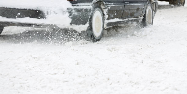 istock car driving on a slippery snow covered road 1225721441
