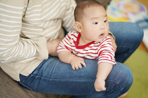 istock A Japanese baby being held by his mother. 1225722282