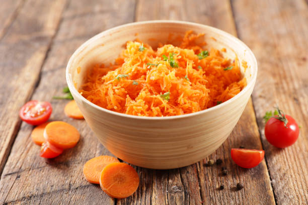 istock fresh grated carrot on wood background 1225724947
