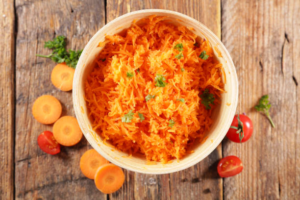 istock fresh grated carrot on wood background 1225724953
