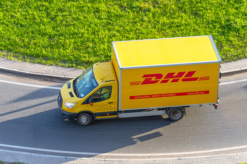 DHL world wide courier company delivery truck on the highway city. Russia, Saint-Petersburg 08 may 2020