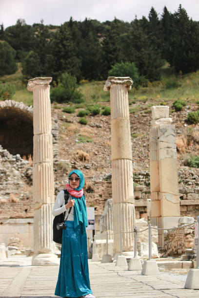 Italy, Rome, Roman Forum, asian hijab woman looking at Arch of Septimus Severus