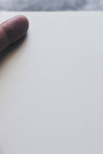 istock White blank page of notebook, diary or journal and hand for writing text or message and ideas on concrete background with copy space. Minimalism lifestyle of business and education concept 1225728828