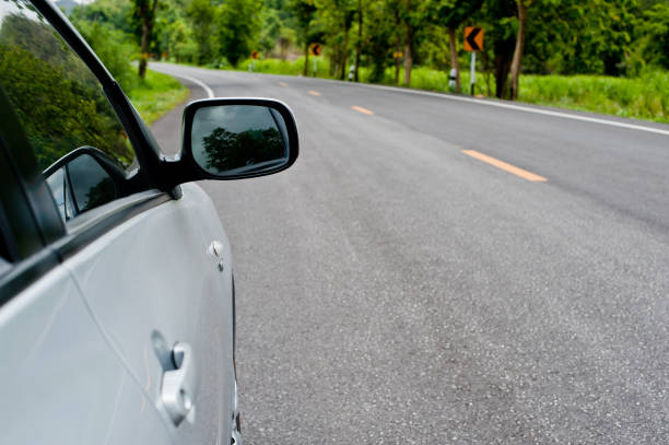 istock Rear side perspective view of car on road countryside 1225729892
