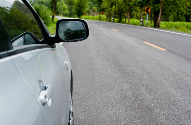 istock Rear side perspective view of car on road countryside 1225729893