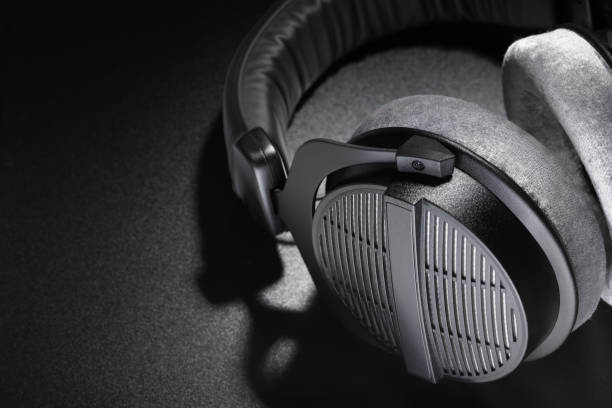 istock Black studio headphones on dark background 1225731158