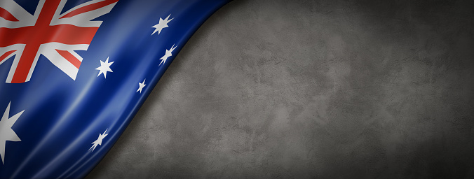 Australia flag on concrete wall. Horizontal panoramic banner.