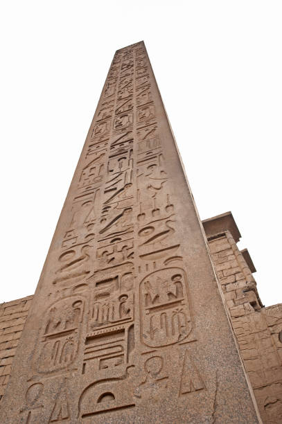 A detailed view of two large ancient-Egypt-inspired pharaoh statues standing against carved sandstone walls featuring hieroglyphics and traditional Egyptian artwork, capturing the themed architectural design and cultural aesthetic of WAFI Mall in Dubai