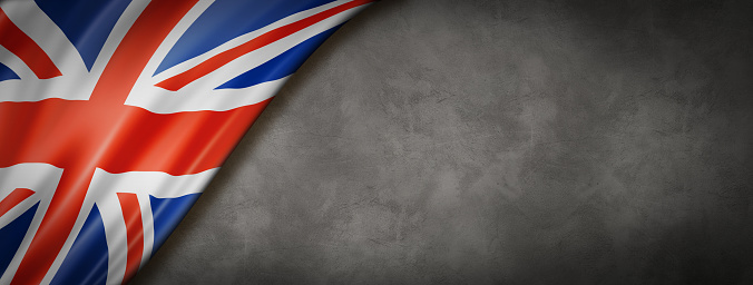 United Kingdom, UK flag on concrete wall. Horizontal panoramic banner.