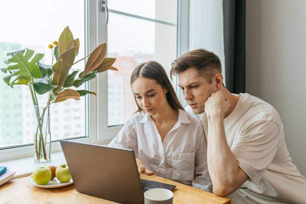 istock young caucasian couple looking for their first purchase online 1225736110