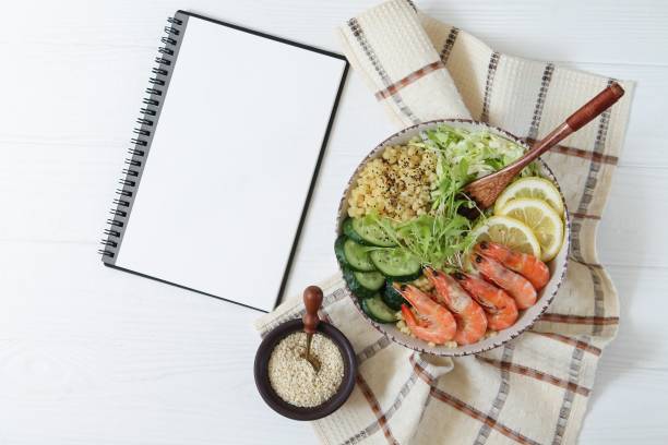 istock Buddha bowl salad and recipe notebook 1225736148
