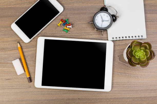 istock White digital tablet on wooden table. Flat lay. 1225737046